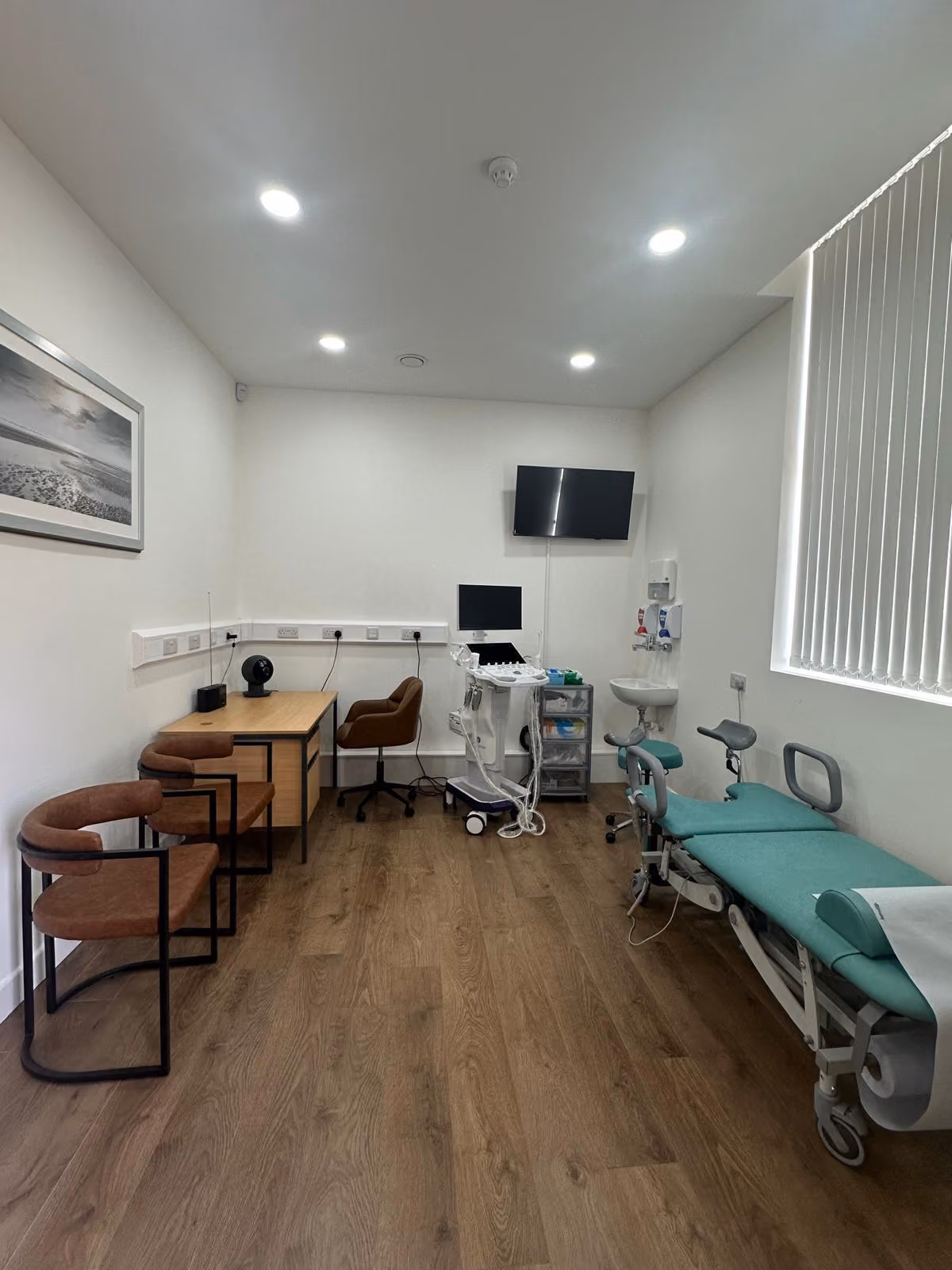 A treatment room at the clinic, with an examination couch and ultrasound scanner.