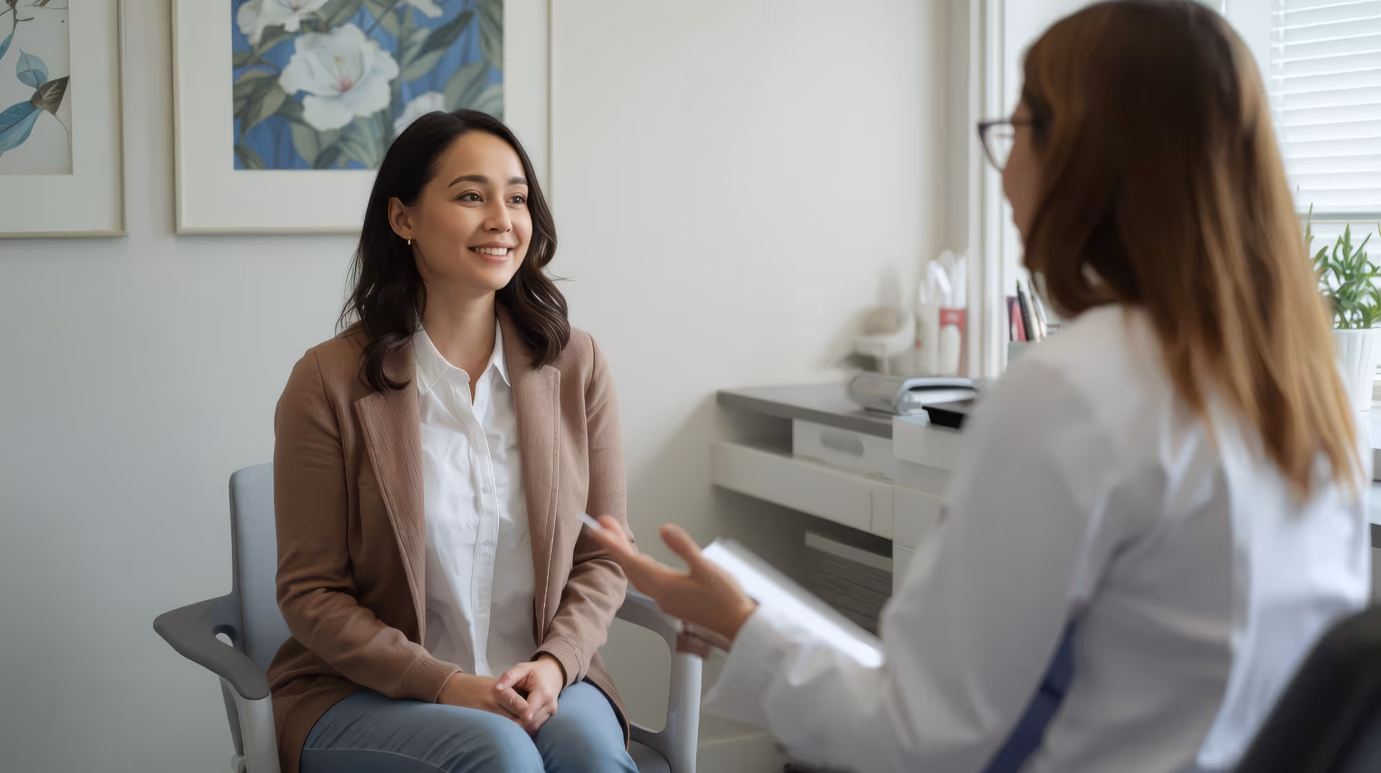 A patient and clinician talking in a consulting room.
