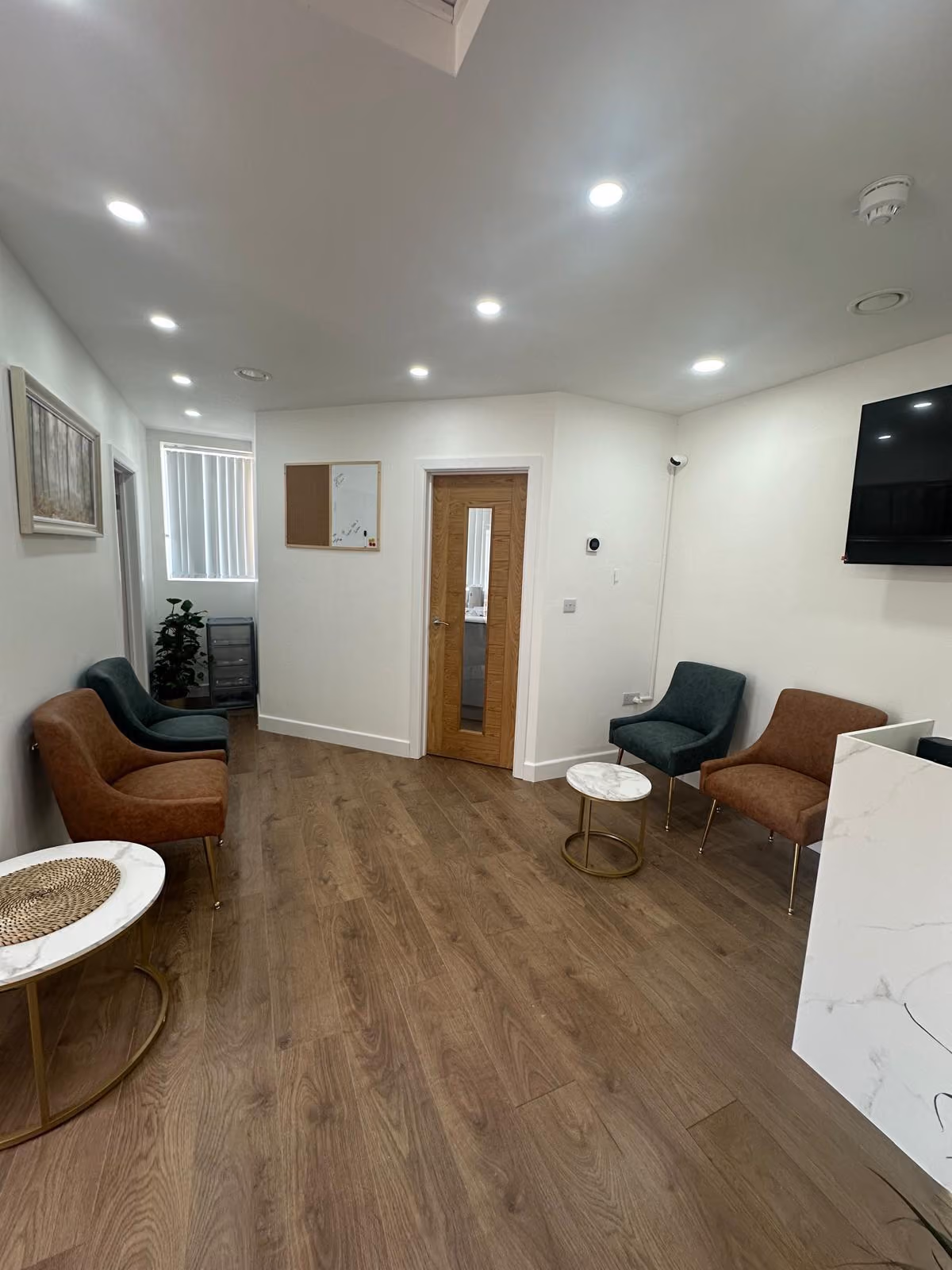 The waiting area at Althea Women&rsquo;s Healthcare, with armchairs and a wooden floor.